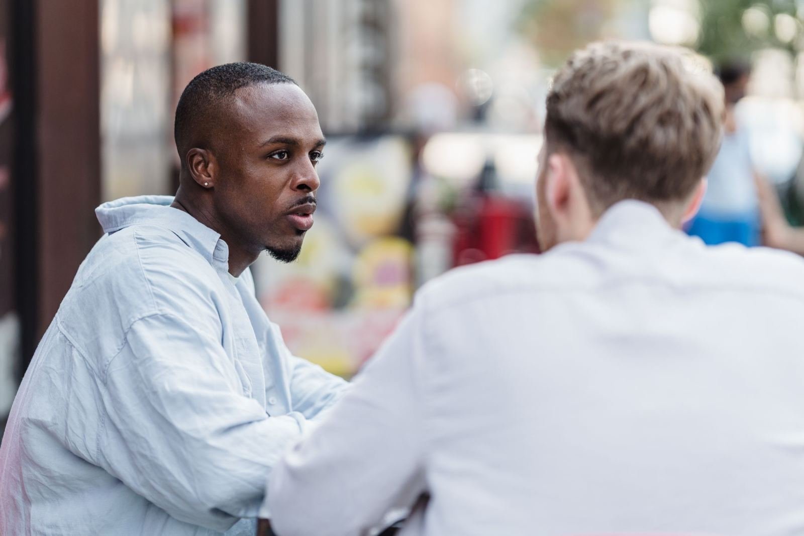 A pair of men chatting outside
