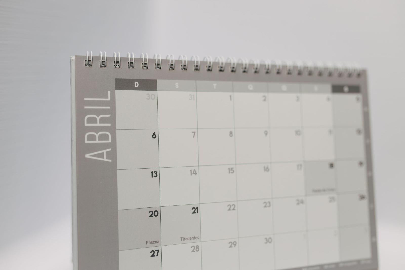 A close-up of a spiral-bound monthly calendar for April