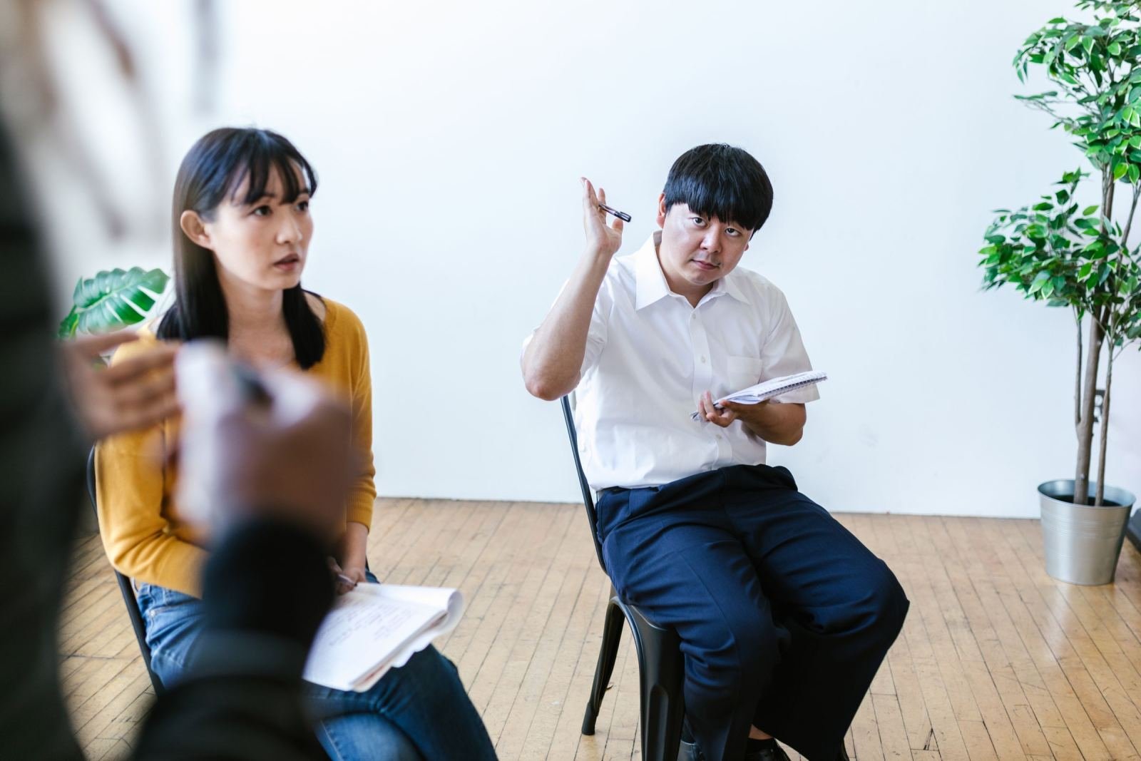 A clinician talks with a man and woman in a well-lit office