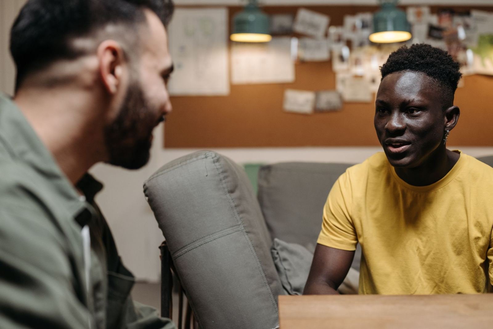 Two men talking to each other in a living room
